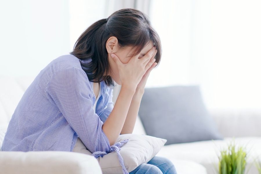 depressed woman on couch