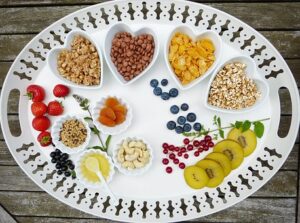 tray of healthy fruits, nuts, and pulses