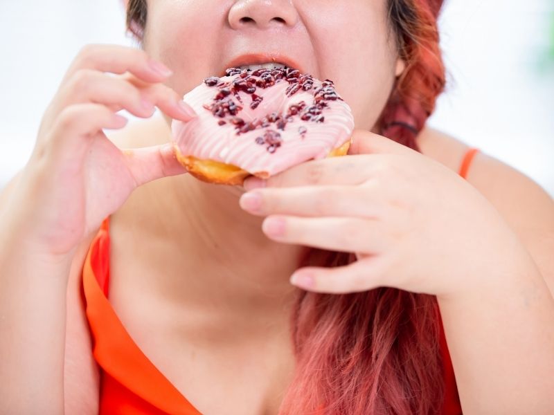 woman eating doughnut