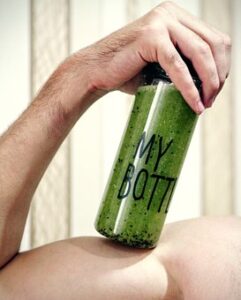 green superfood smoothie in a bottle