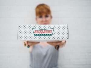 woman holding donuts