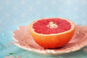 half a sliced of pink grapefruit on a plate