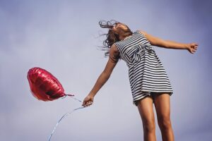 woman with a heart shaped baloon