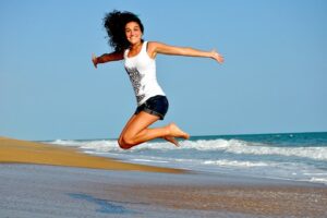 woman jumping in sand