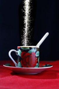 white table sugar flowing into mug