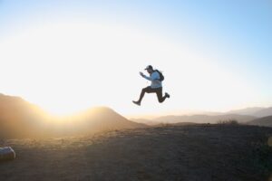 man jumping with rucksack