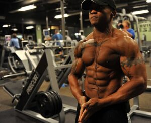 man in gym with toned muscly body