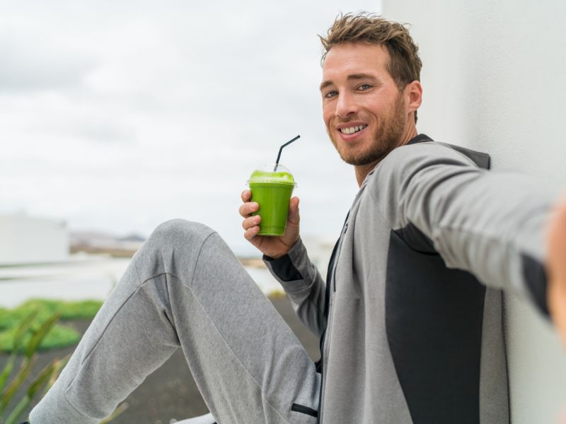 man drinking greens