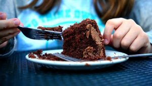 girl eating chocolate cake